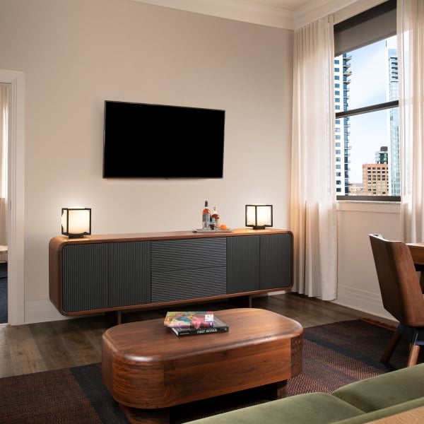 The living room area of a Marble Suite with a tv and furniture