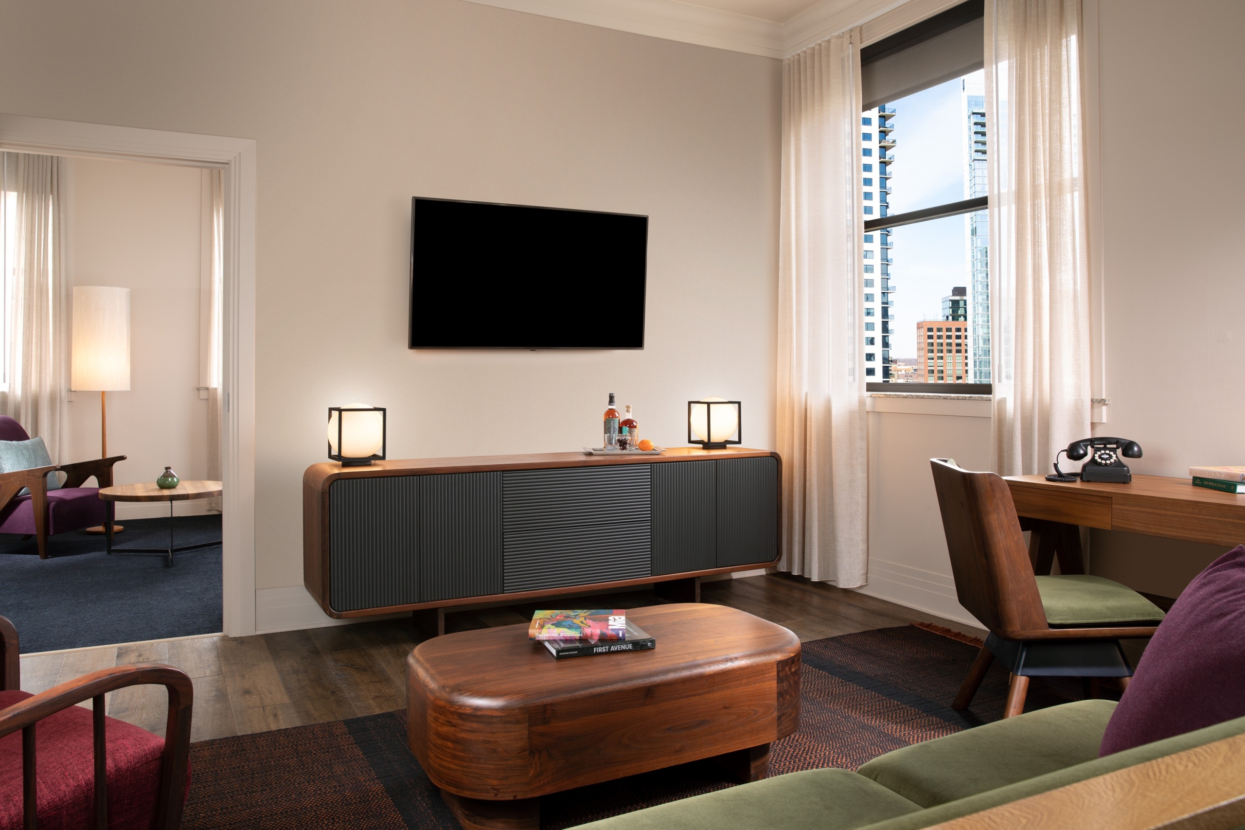 The living room area of a Marble Suite with a tv and furniture