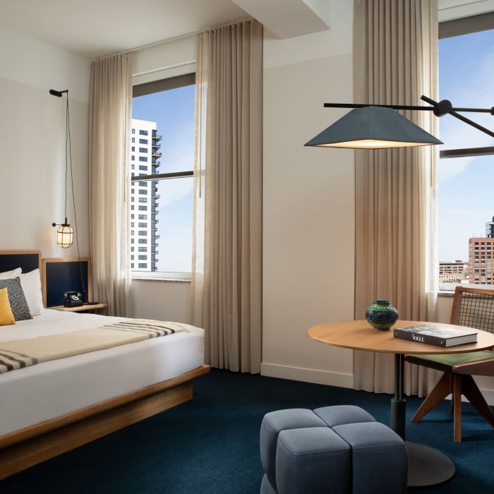 A spacious bedroom with a table and chairs.