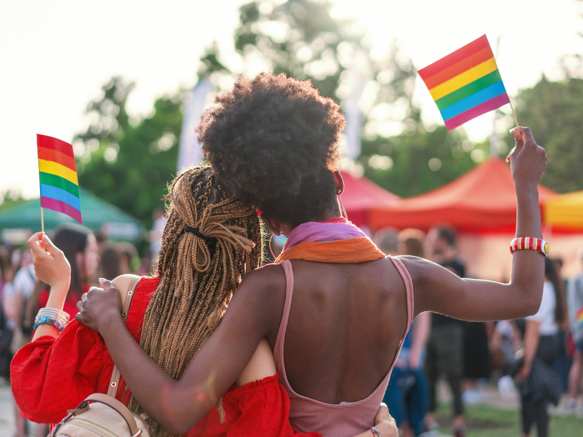 Two women holding pride flags