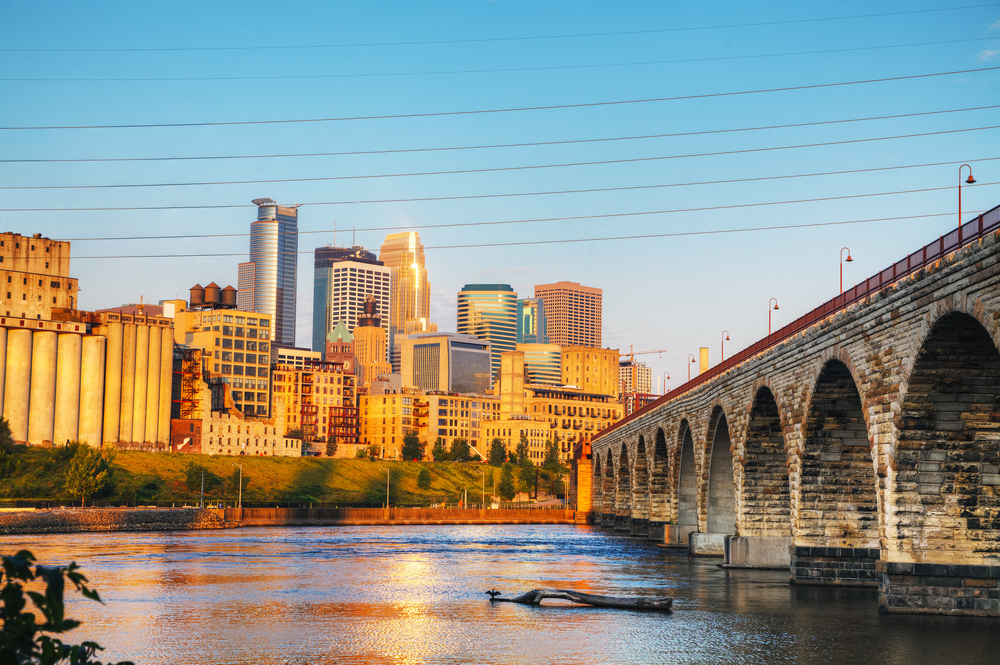Stone Arch Bridge with the river, and buildings in the background