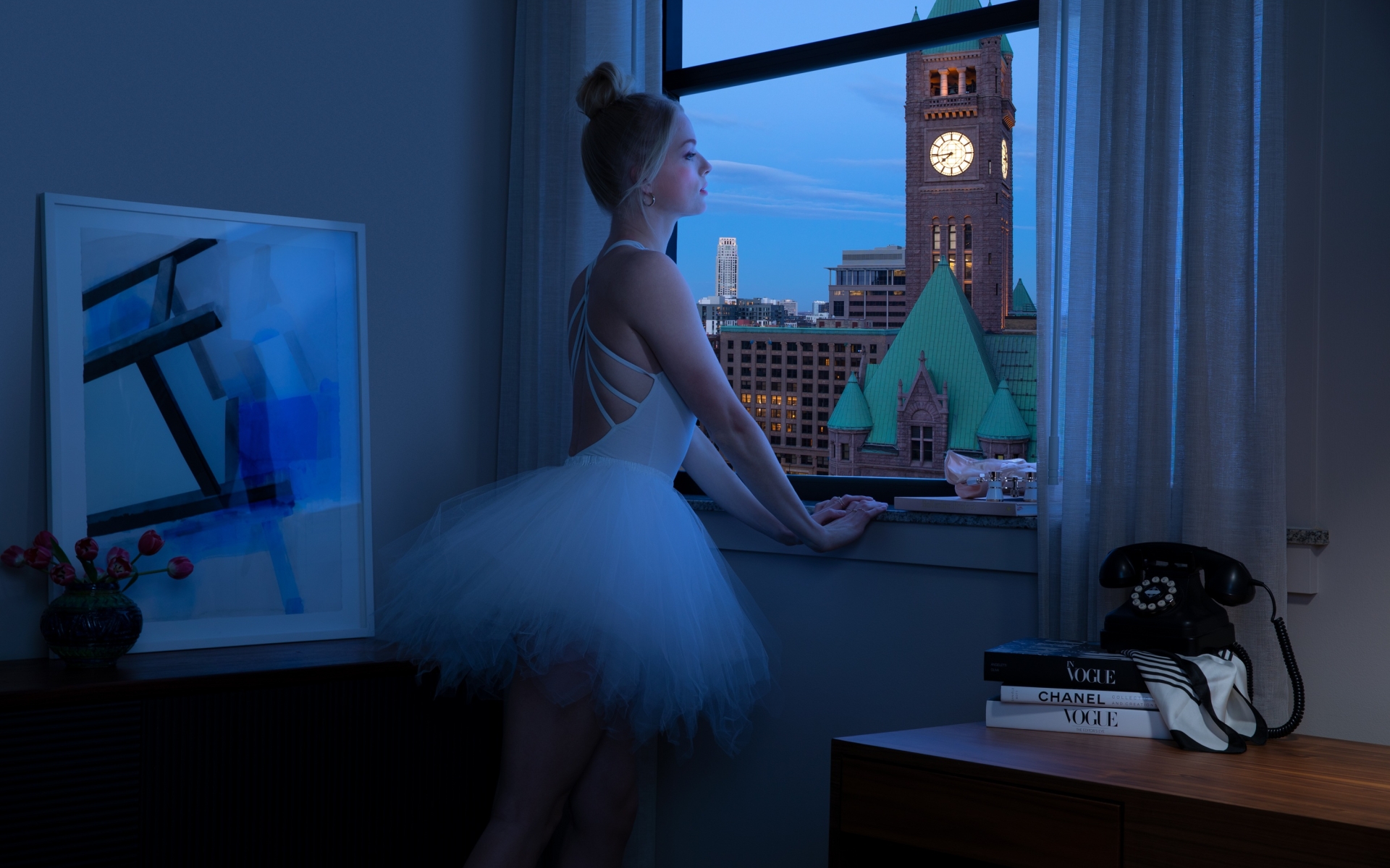 A ballerina looking out the window