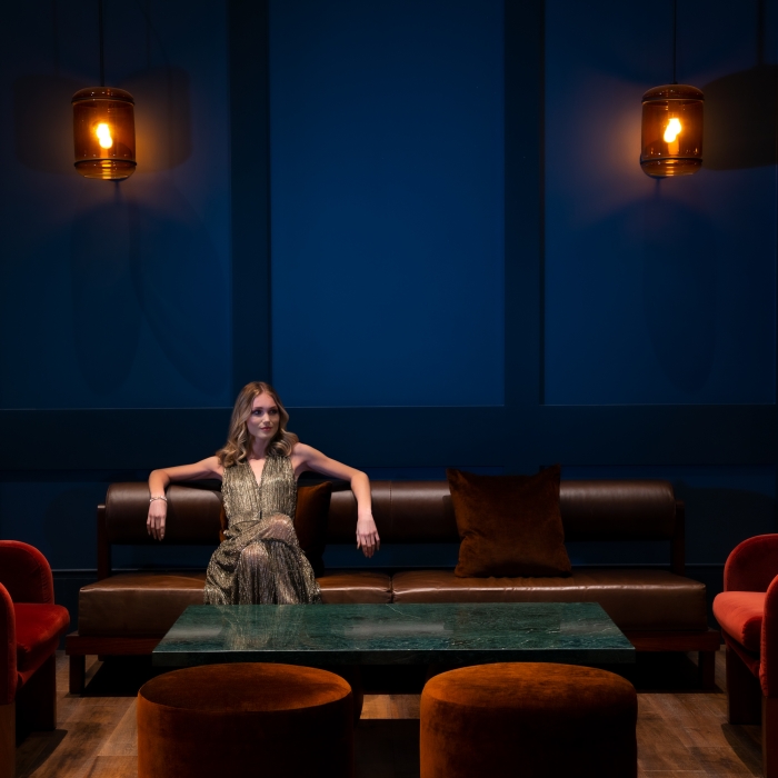 Woman lounging on a brown leather sofa