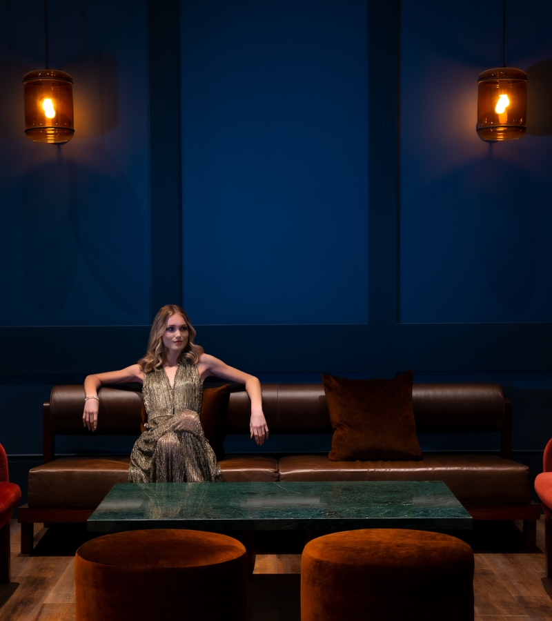 Woman lounging on a brown leather sofa
