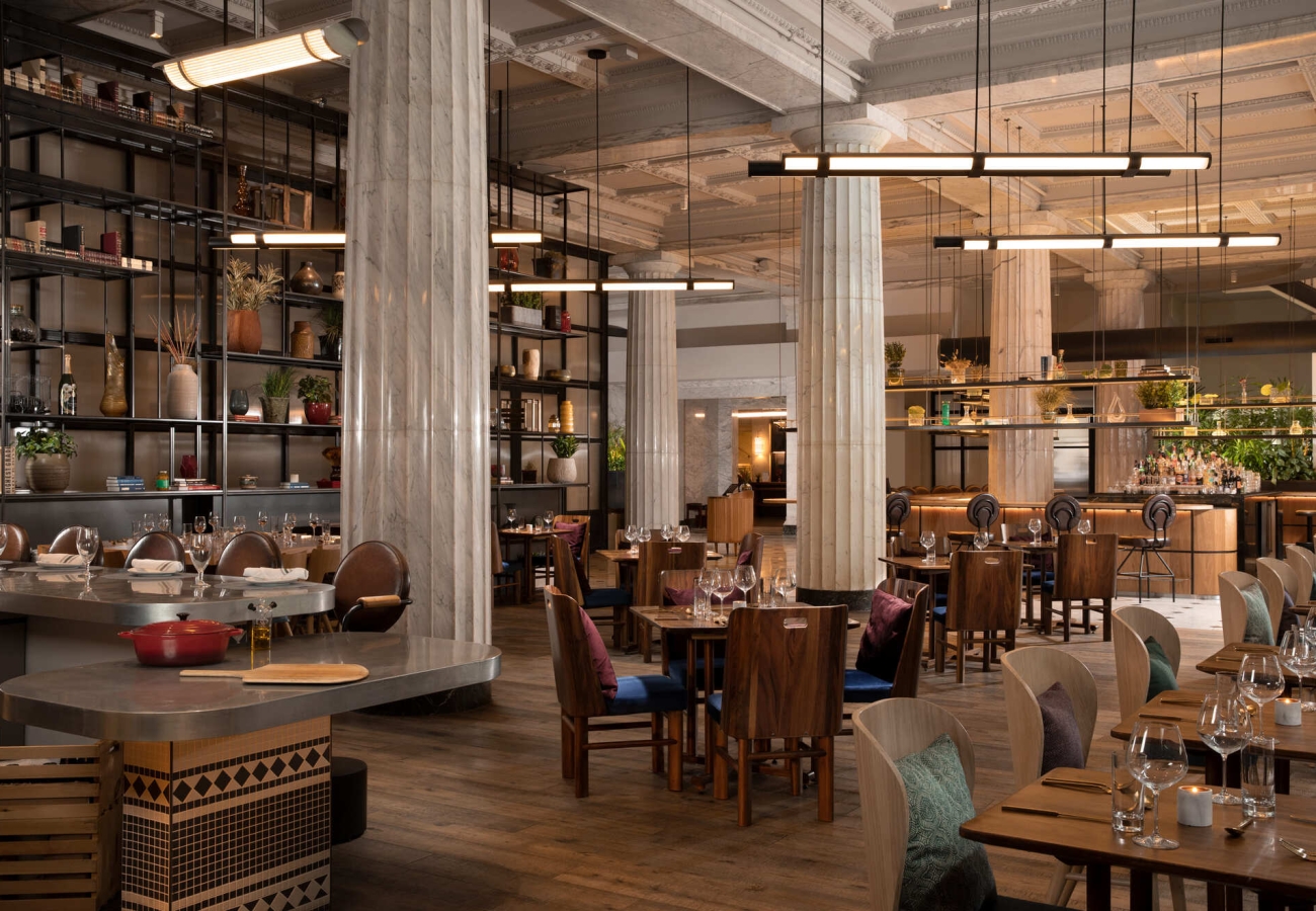 Interior of Giulia restaurant with many wooden tables