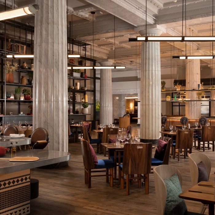 Interior of Giulia restaurant with many wooden tables