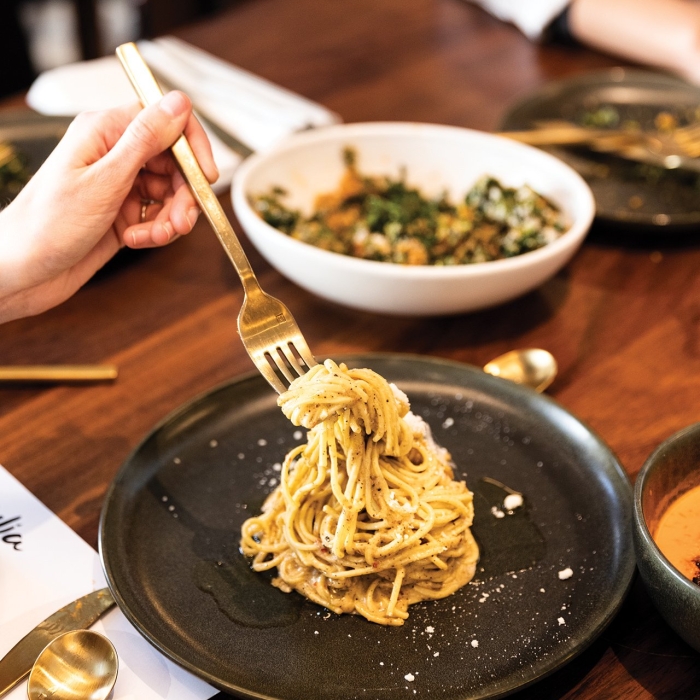 A plate of fresh pasta on a dining table.