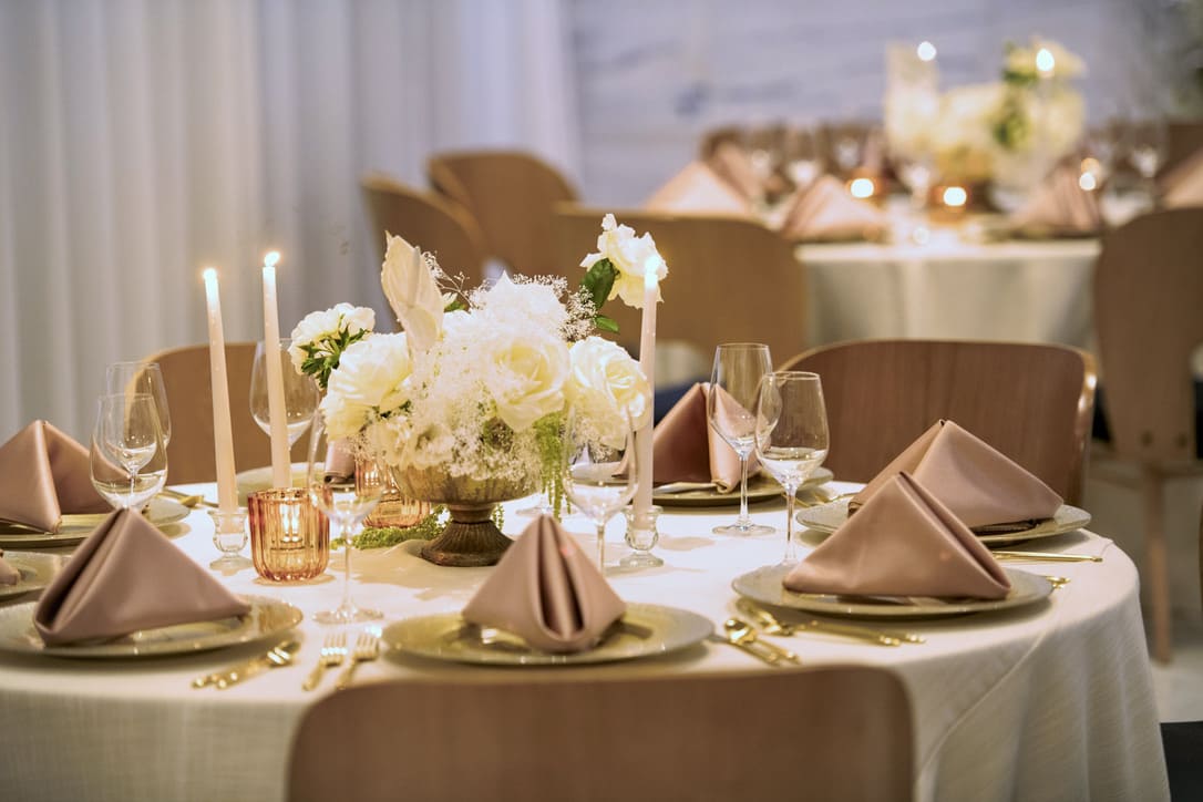 guest table set for a wedding with white tablecloths