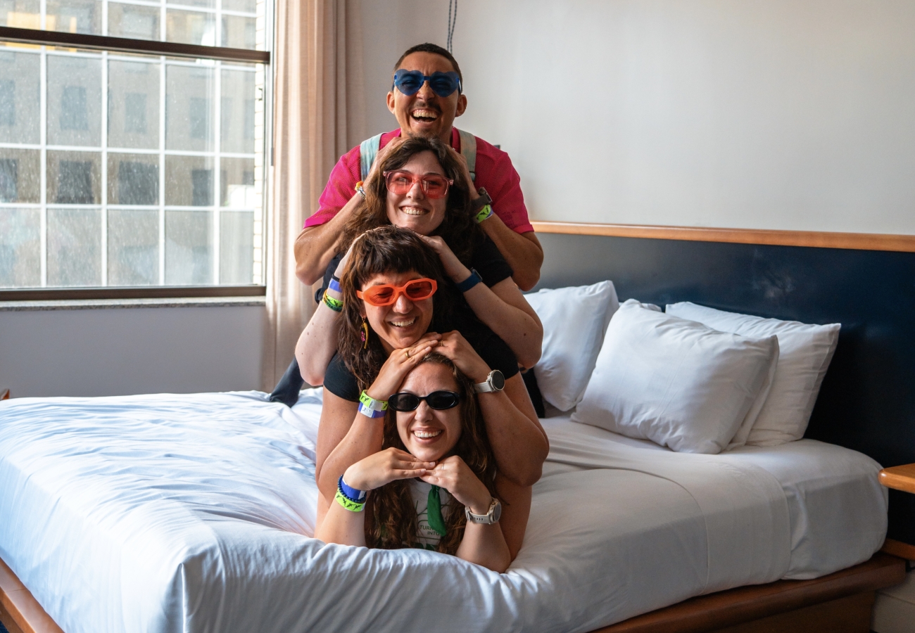 Four friends laying on bed