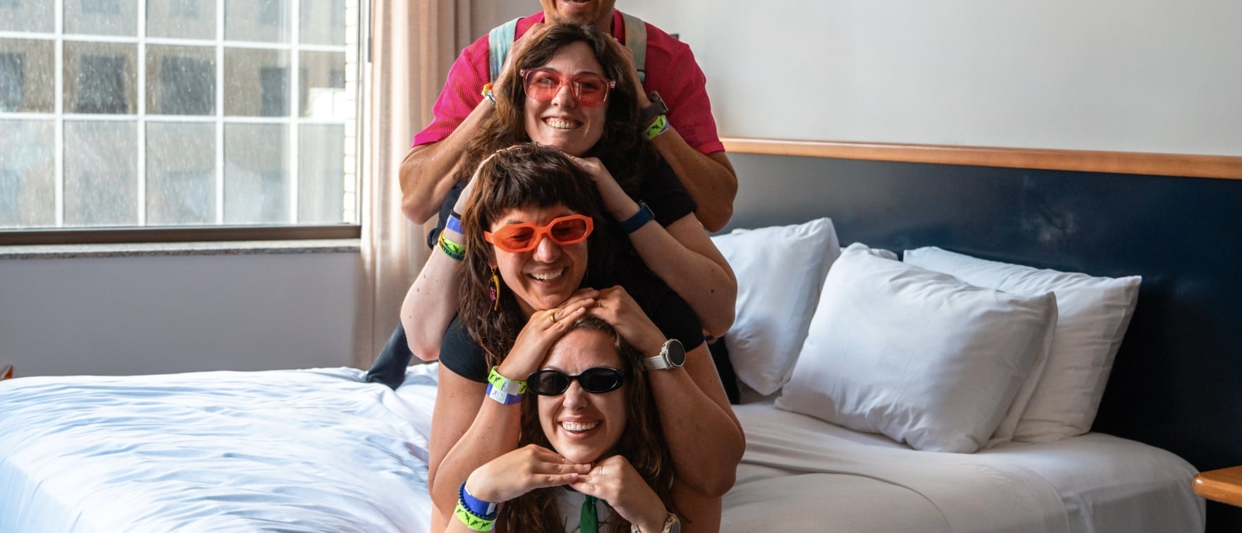Four friends laying on bed
