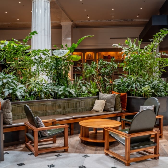 Cozy seating area surrounded by plants and marble