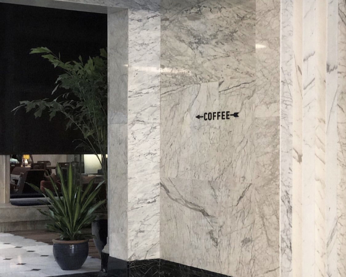 Marble hallway with coffee sign