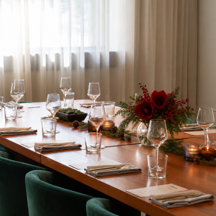 Elegant set table with holiday table decorations and large window