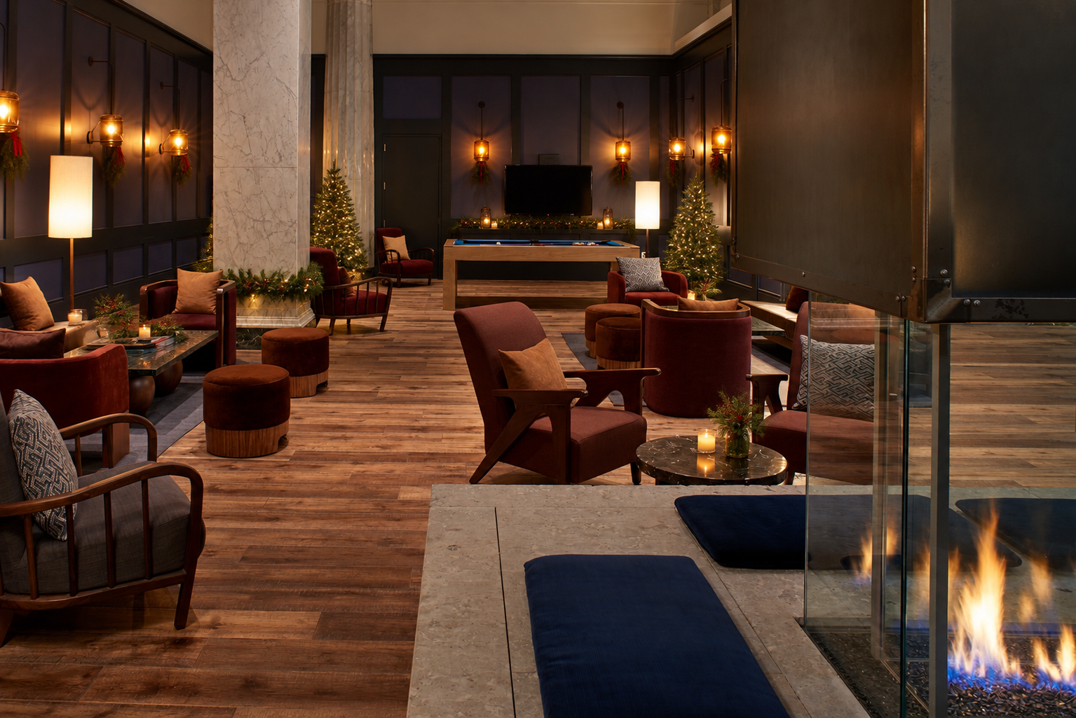 Elegant lounge seating with fireplace and holiday decor